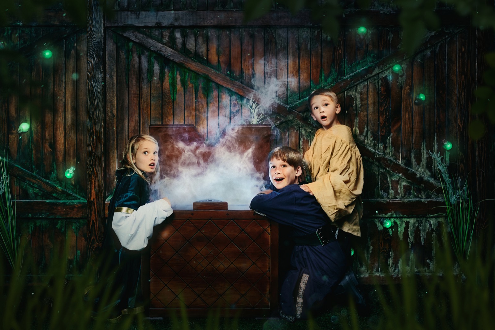 Kids at an escape room birthday party react as smoke rises from a wooden chest inside Spell Breakers