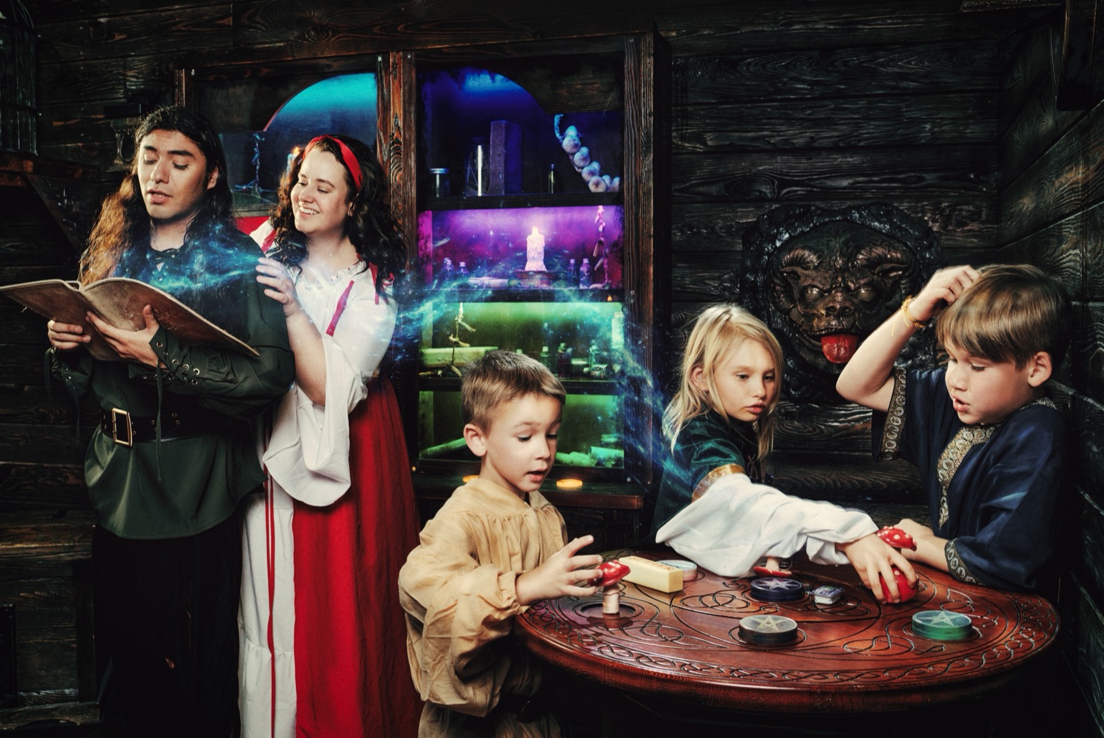 Kids at an escape room birthday party in Spell Breakers as two costumed characters cast a glowing spell